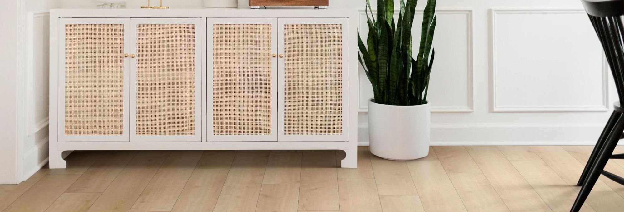 A white cabinet in a room with wood-look laminate flooring from Novakoski Floor Covering in Anderson, IN