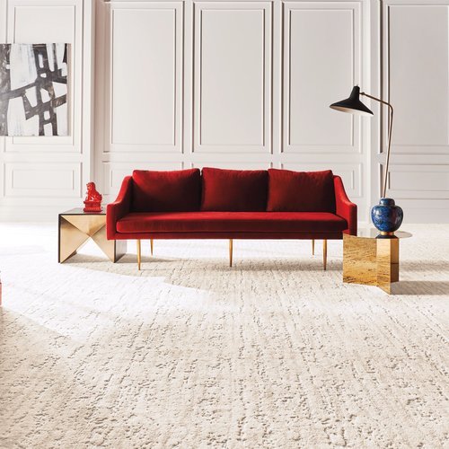 Bright living room with red velvet couch and beige textured carpet from Novakoski Floor Covering in Anderson, IN