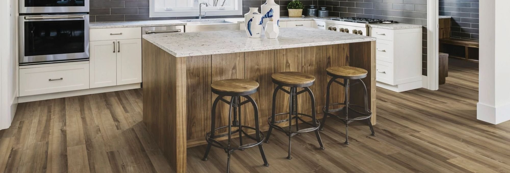 Kitchen and dining area with wood-look luxury vinyl flooring from Novakoski Floor Covering in Anderson, IN